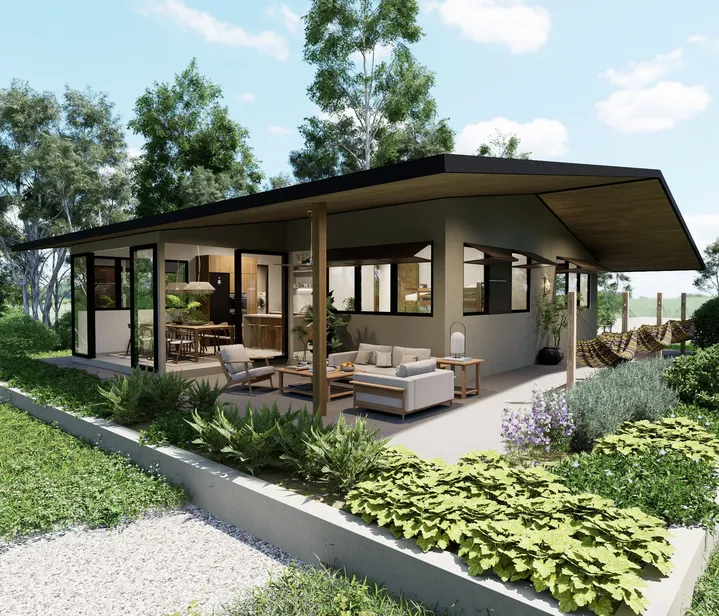 Vista del exterior de la casa con puertas de vidrio, muebles de exterior y jardines, diseñada para aprovechar la luz natural y el paisaje.