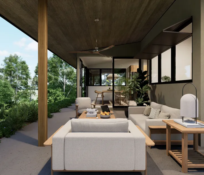 Covered, well-ventilated area with a sofa, rustic table, and a seamless transition to the dining space, surrounded by tropical greenery.