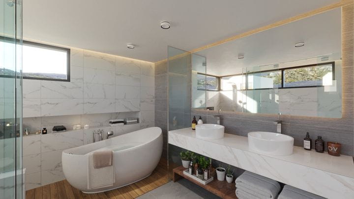 Área de baño con bañera exenta en piedra natural